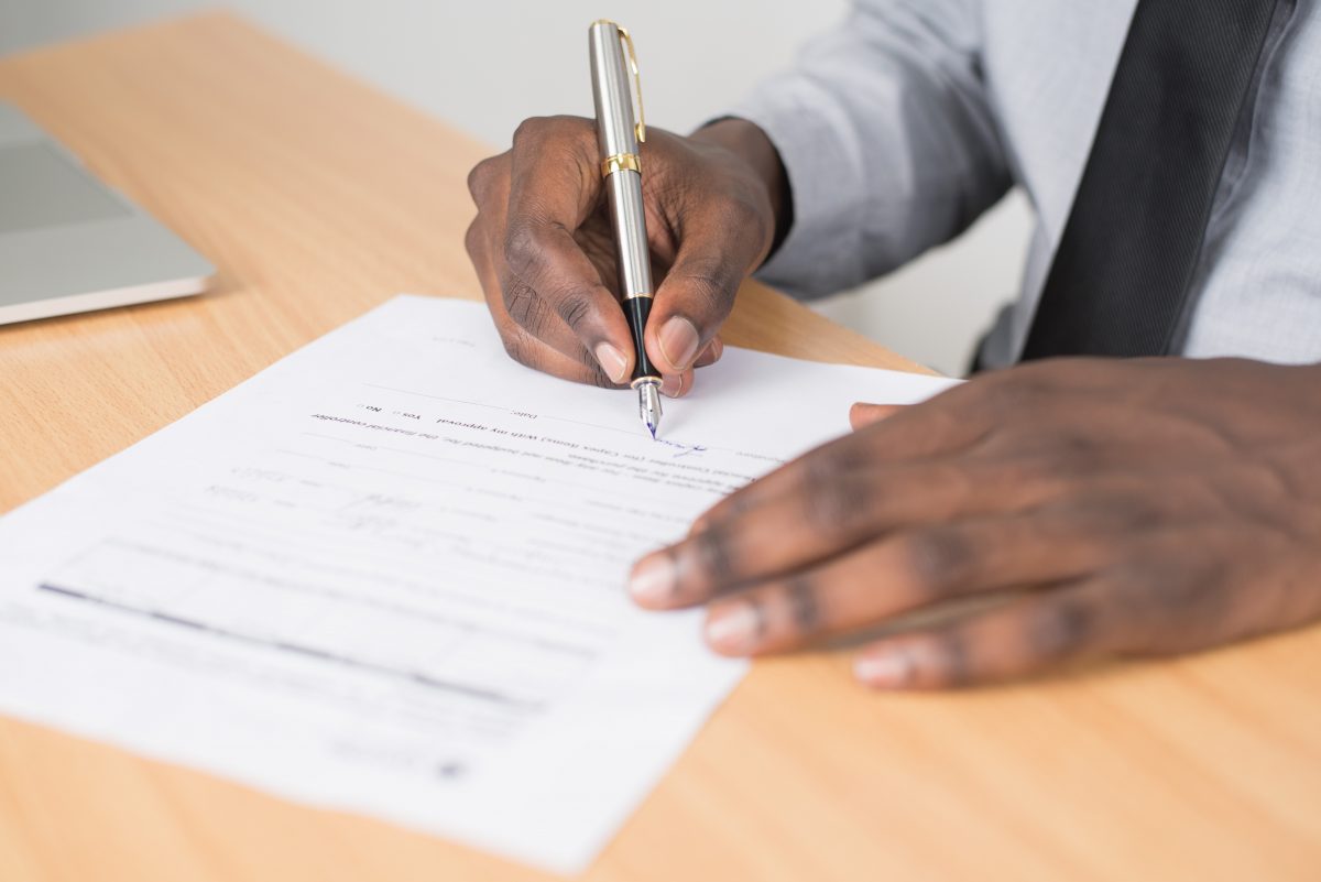 A man reviewing and signing a will
