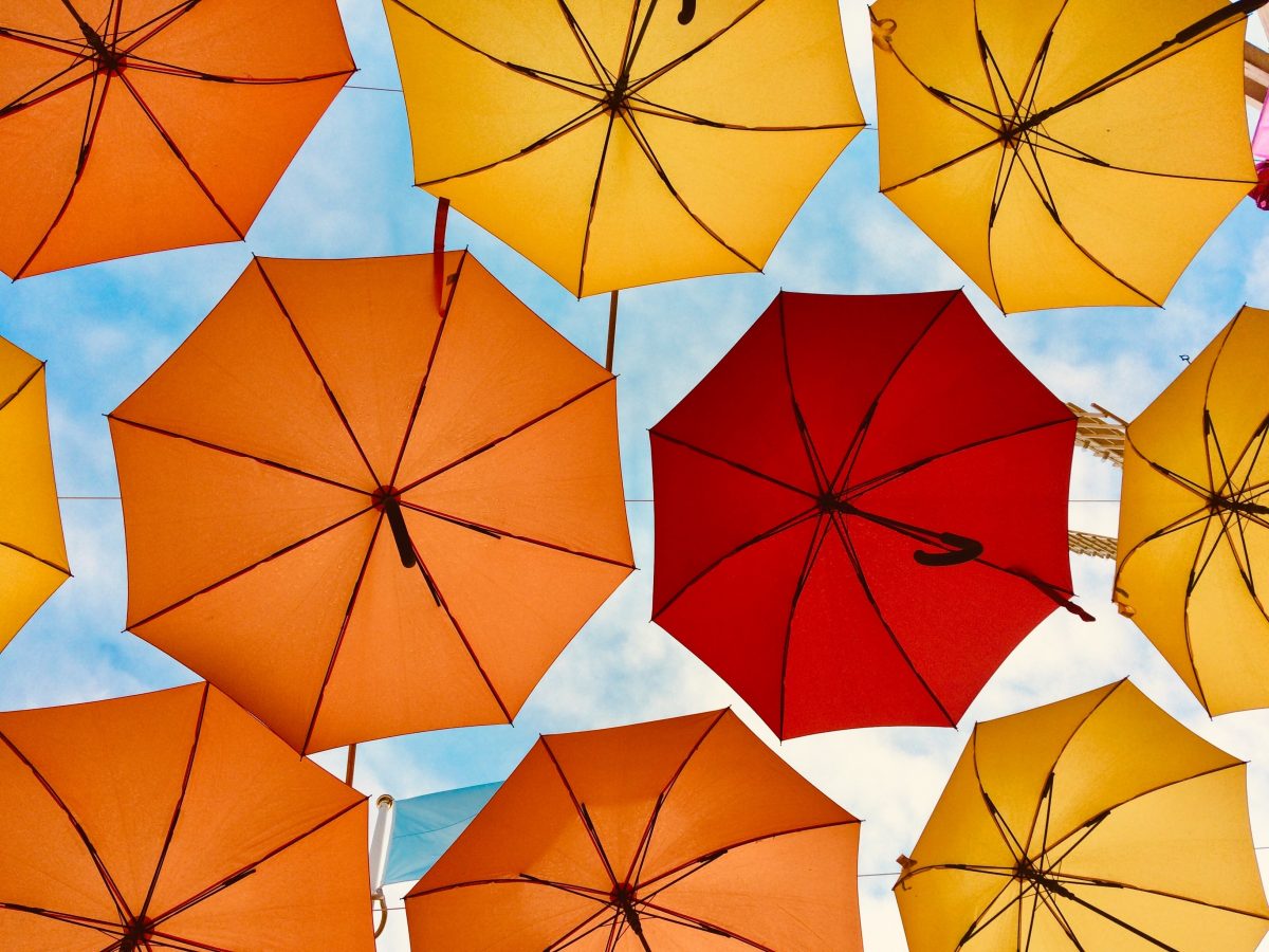 Yellow, orange and red umbrellas in the sky